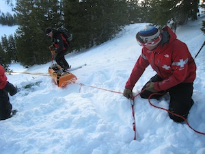 Person helping with an avalanche rescue
