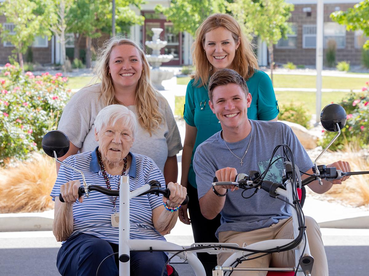 Group of people showing off an adaptive bicycle