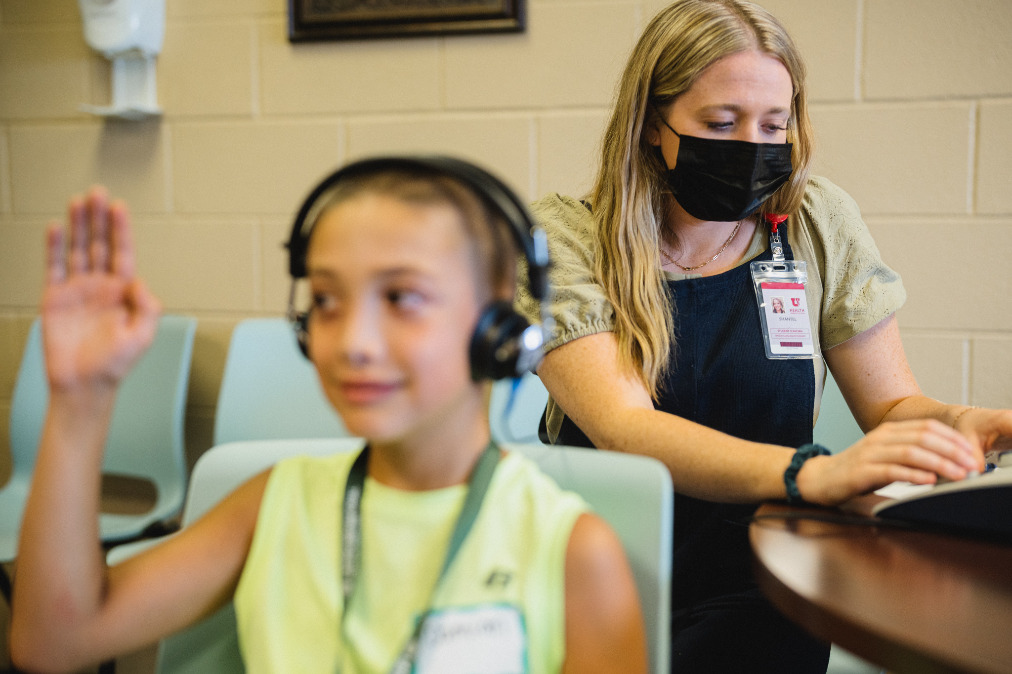 Woman giving a child a hearing test