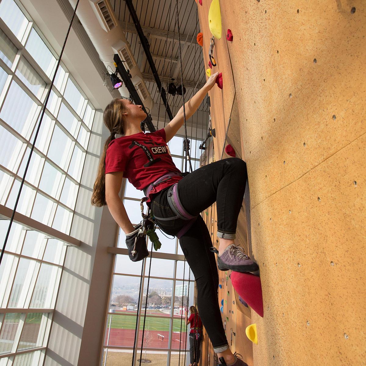 Student on a climbing wall at the Student Life Center