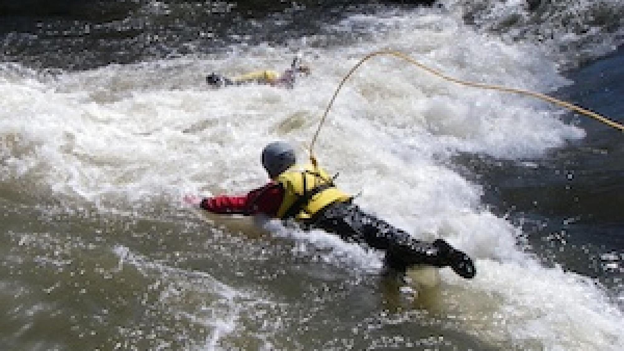 Person performing swiftwater rescue techniques
